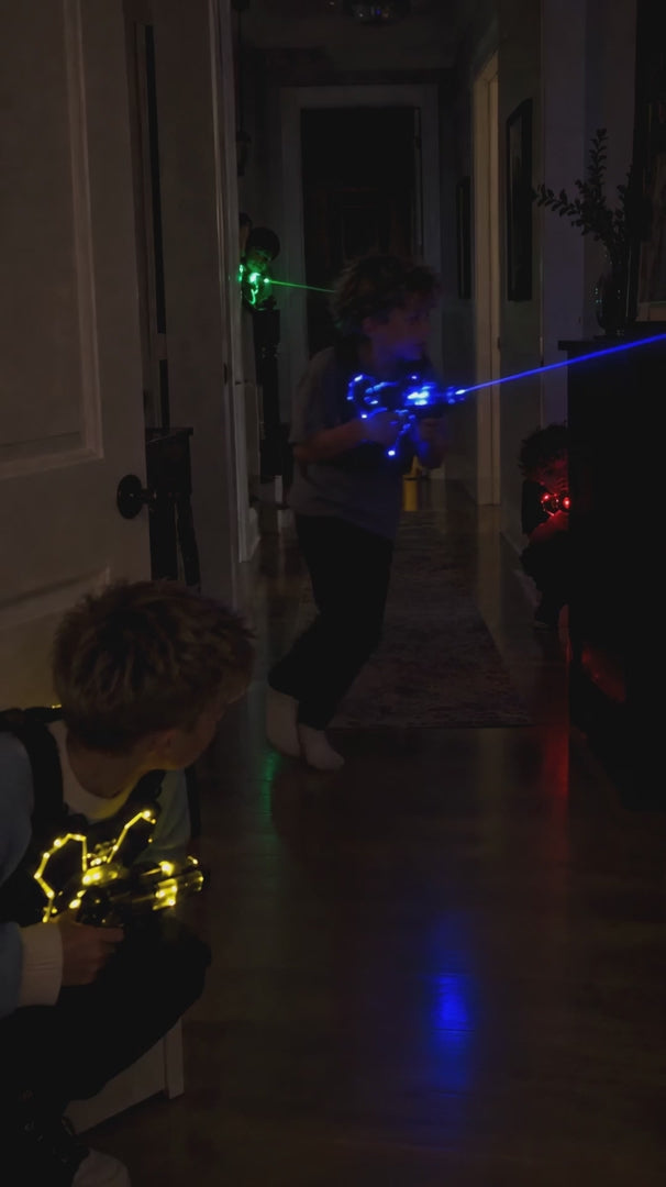 Kids playing LaserFury laser tag in a dark hallway